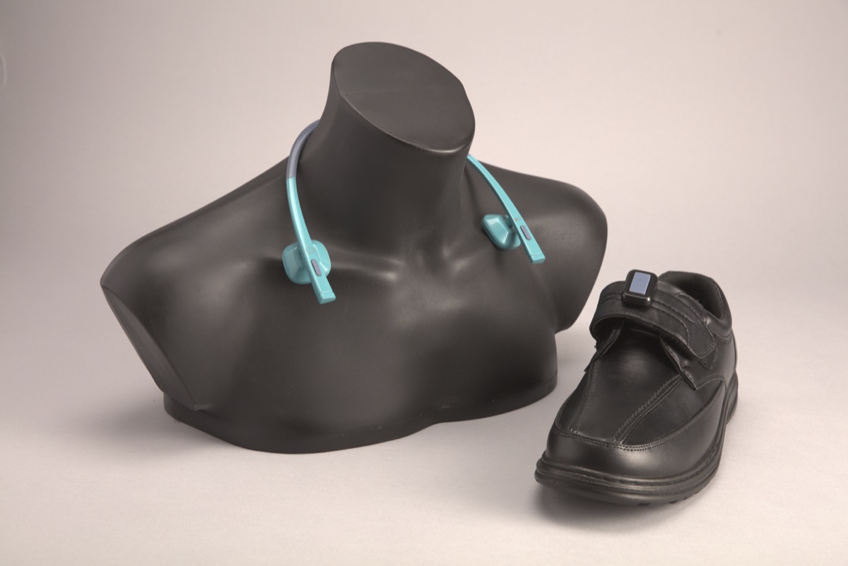 The original Peter prototype, a bone-conduction headset on a mannequin next to a walking shoe
